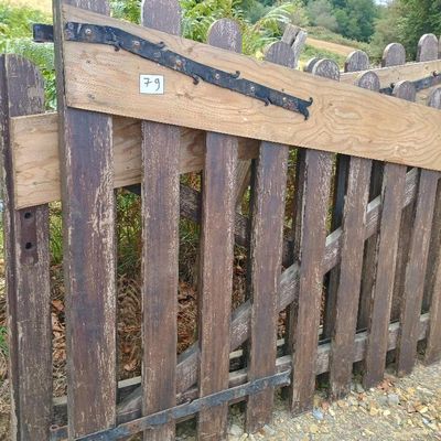 une clôture en bois sur laquelle est accrochée une pancarte