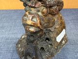 a statue of a woman holding a bird on a rock