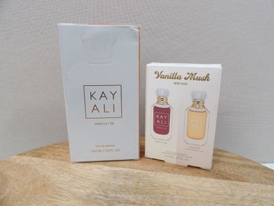 two bottles of perfume sitting on top of a wooden table