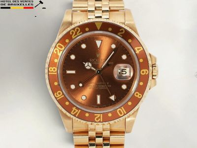 une photo d'une montre Rolex en or avec un cadran marron