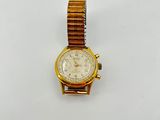 an image of a gold watch on a white surface