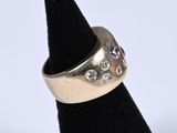 a close up of a gold ring on a black ring holder