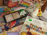a box full of toys and books on a table