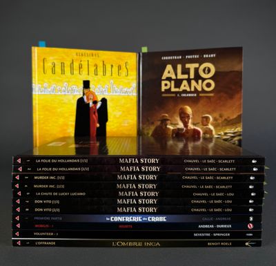a lot of books that are stacked on top of each other