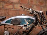 a motorcycle that is parked in front of a brick wall