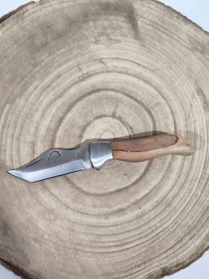 a knife that is sitting on top of a piece of wood