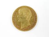 l'image d'une pièce d'or sur laquelle figure le visage d'un homme