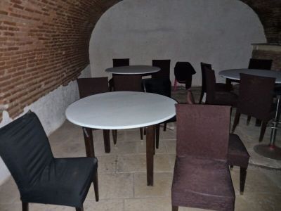 many chairs and tables in a room with a brick wall