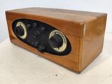 an old fashioned radio sitting on a table