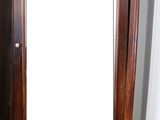 a tall wooden cabinet with a mirror on top of it