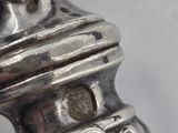 a close up of a metal object with a flower on it