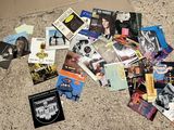 a pile of cds on the floor next to a cardboard box