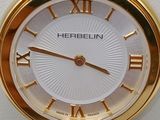 a gold watch with roman numerals on the face