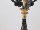 a black and gold candle holder on a white table