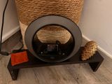 a basket with a phone on a stand next to a basket with a cell phone on it