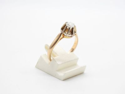 a close up of a gold ring with a diamond on top