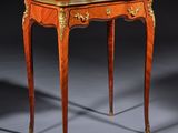a small table with a wooden top and gold trimming