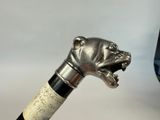 a close up of a walking stick with a dog head on it
