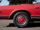 an image of a red car parked in a parking lot