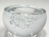 a glass bowl with water in it on a white surface