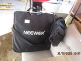 a black bag sitting on top of a couch next to a red chair