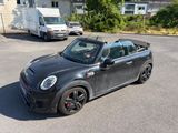 a small black car that is parked in the parking lot
