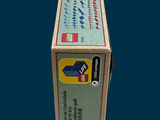 a box of toothpaste sitting on a blue surface