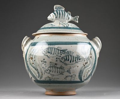 a blue and white vase with a fish design on it