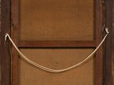 an old wooden frame with a rope hanging from it ' s side