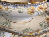 a person that is holding a cup and saucer
