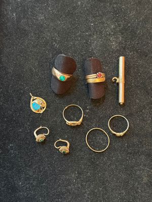 several different rings and rings are laying on a black surface