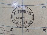a close up of a globe with a stamp on it