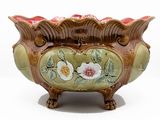 a vase that has flowers on it on a stand