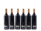 six bottles of wine are lined up on a white surface