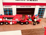 a fire truck and a firetruck in front of a fire station