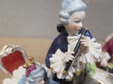 a figurine of a man playing a flute