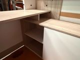 a desk with shelves and shelves in a room