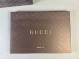 two boxes of gucci perfume sitting on a table next to each other