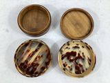 two small wooden boxes with a brown and white design on them
