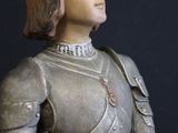 a statue of a woman in a suit of armor