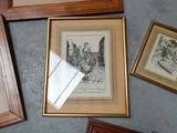 many framed pictures on the floor of this room