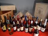 many bottles of wine sitting on a table with a red cloth