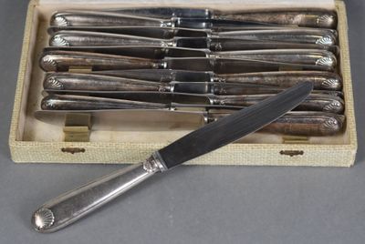 six knives in a wooden box with a knife on top of it