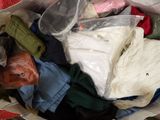 a bag full of clothes that is sitting on the floor