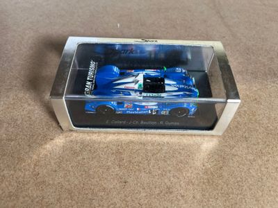 a close up of a toy car in a box on a carpet