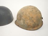two helmets are sitting next to each other on a white surface