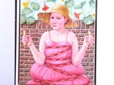 a painting of a woman in a pink dress and a straw hat on a easel