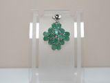 an image of a close up of a pair of earrings with green stones
