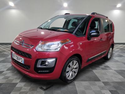 the red citrole is parked in a large room