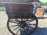 a wooden wagon with a wooden box on the back of it